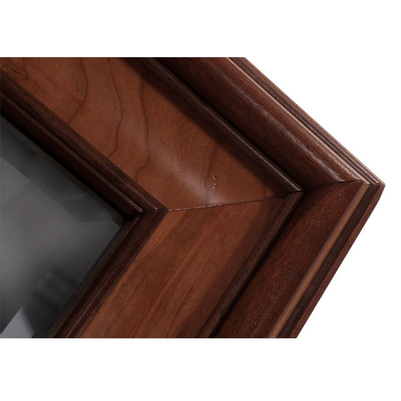 Close-up of a wooden mirror frame with mitered corner joints.