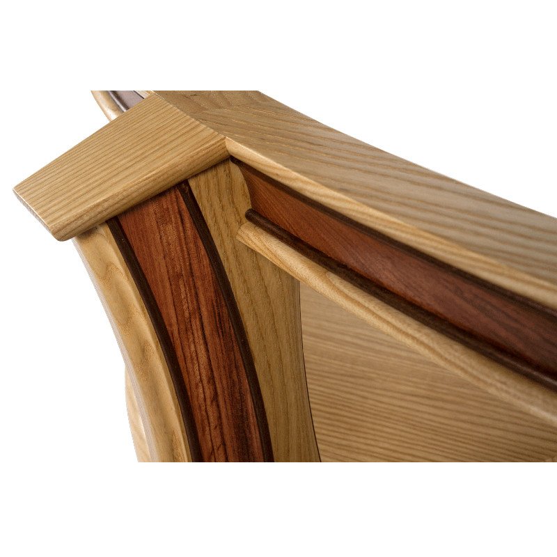 Close-up of a curved wooden coffee table leg showing different wood grains and colors.