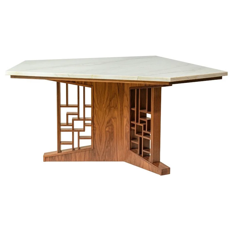 A wooden table with a white quartzite top, featuring geometric cutouts in its base for decorative design.