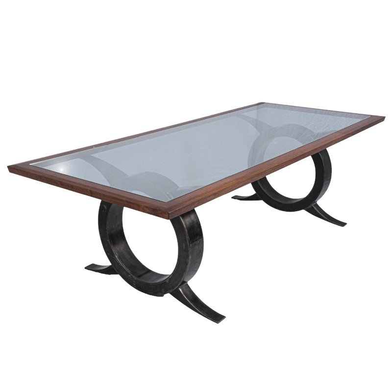 A modern rectangular dining table with a glass top and wooden frame, supported by two black curved metal legs.