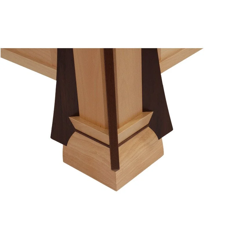 Close-up of a wooden bed frame with a combination of light and dark wood, showcasing a craftsmanship detail at the base.