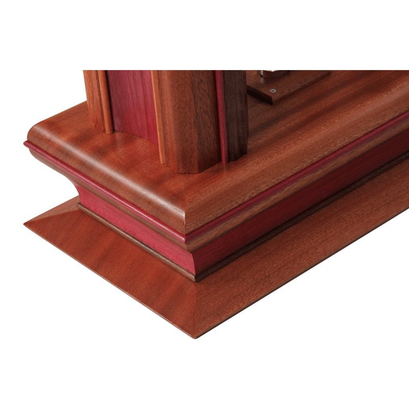 Close-up of a wooden lamp base with detailed craftsmanship and a polished finish.