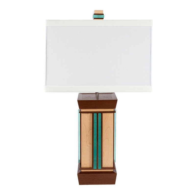 A modern table lamp with a rectangular white lampshade and a geometric wooden base featuring vertical teal acrylic accents.