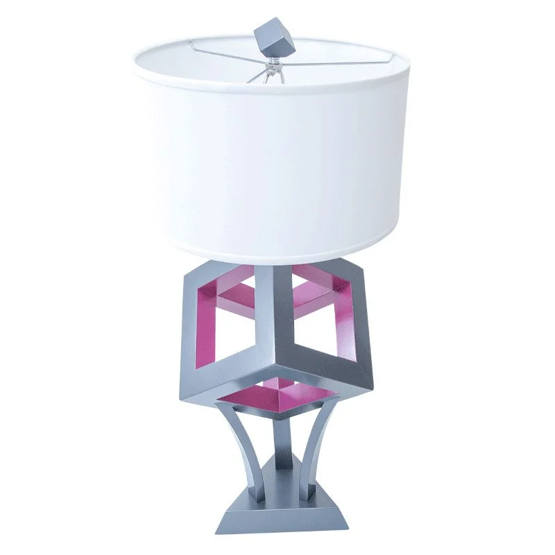 A modern decorative lamp with a geometric base and a white lampshade.