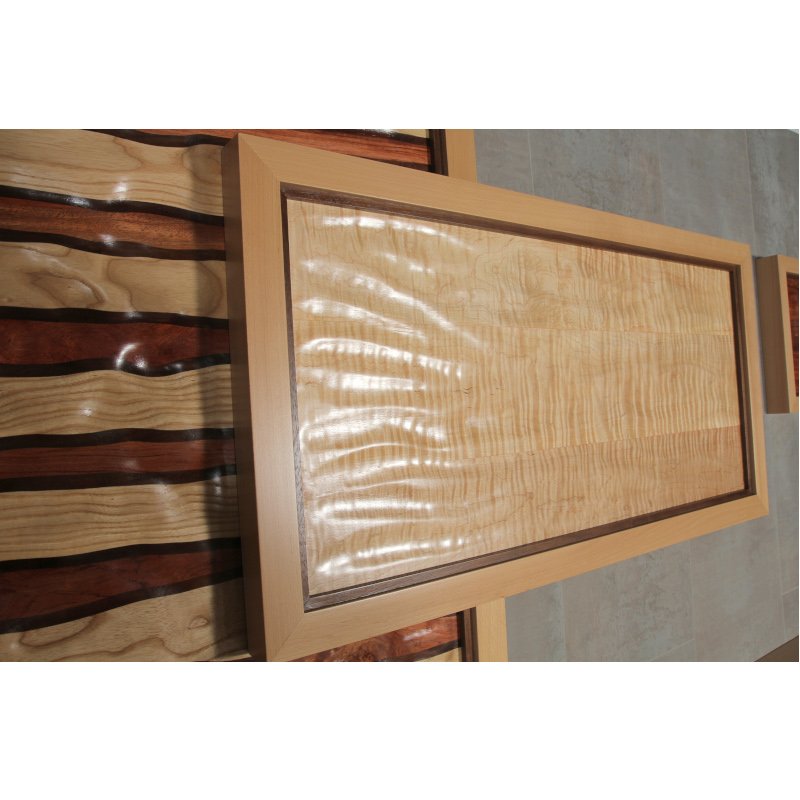 Wooden wall art with carved textures inside of stacked overlapping frames.