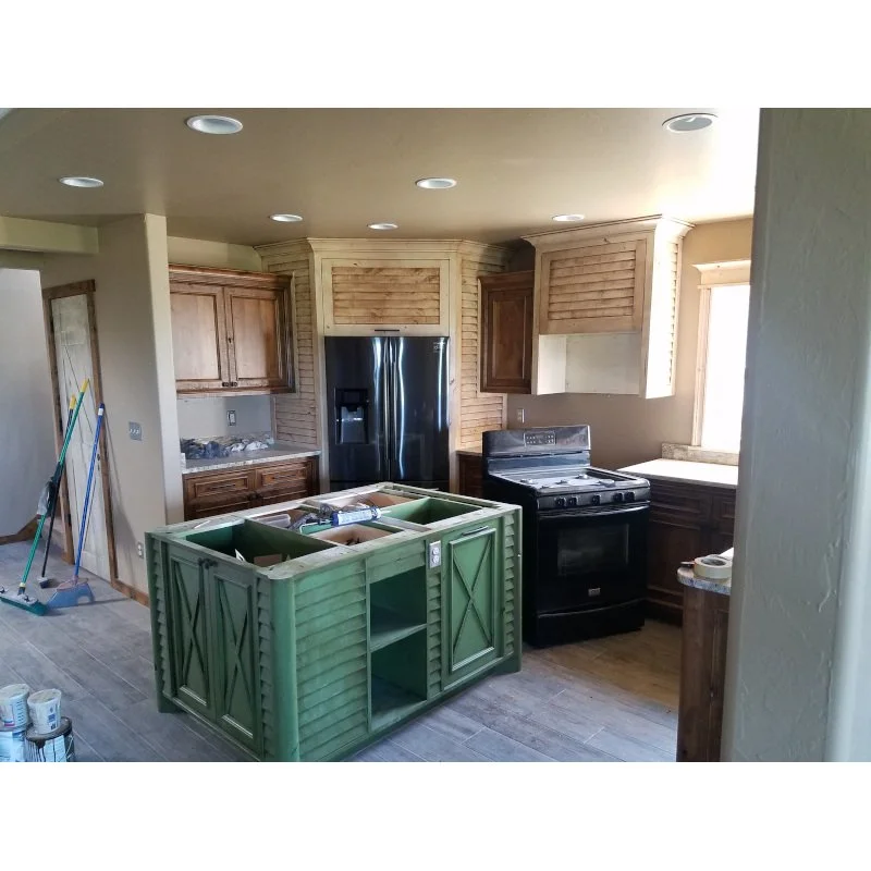Custom rustic kitchen with knotty alder and green painted island.