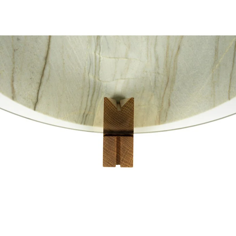 Close-up of the leg detail on a modern coffee table with wood, glass, and stone.