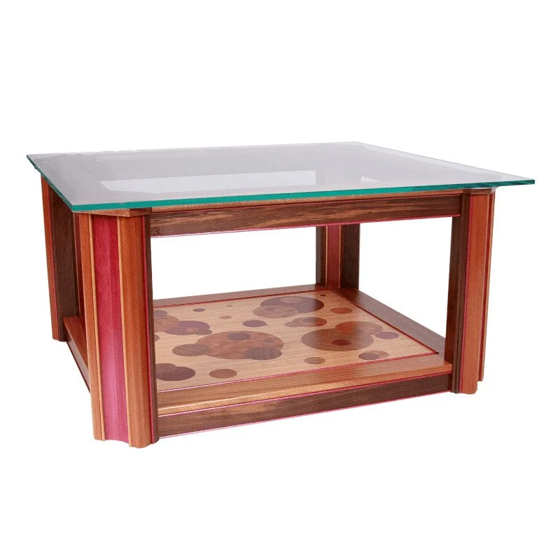 A wooden coffee table with a glass top and a decorative wood inlay on the lower shelf.