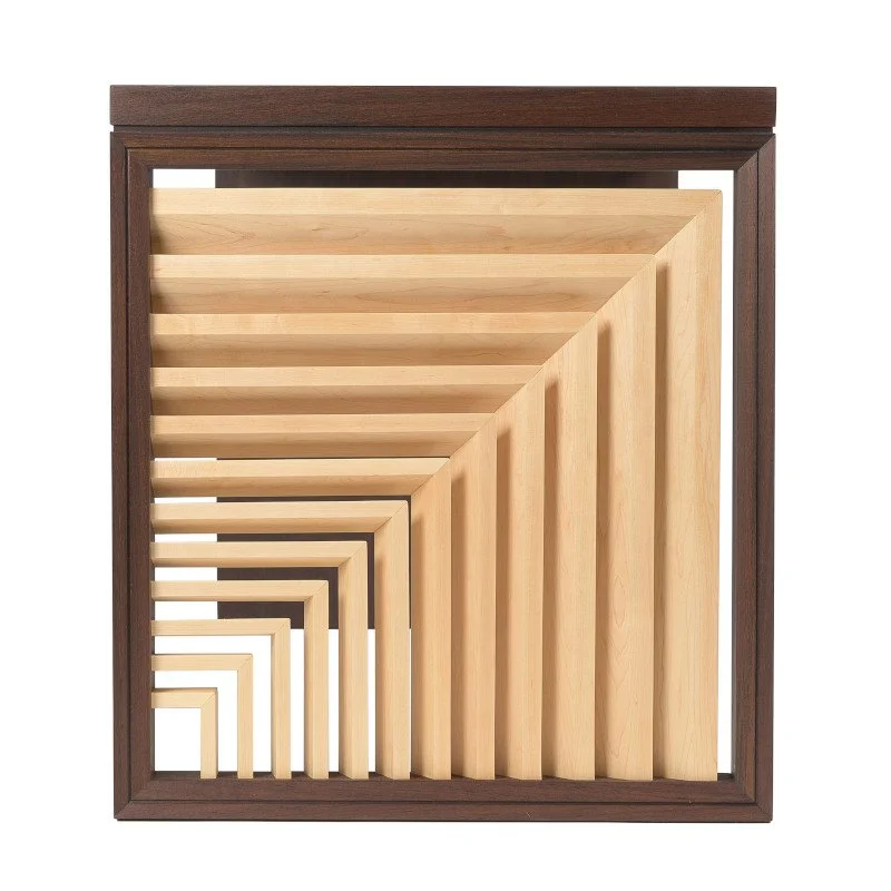 A decorative side panel on a custom wooden writing desk.