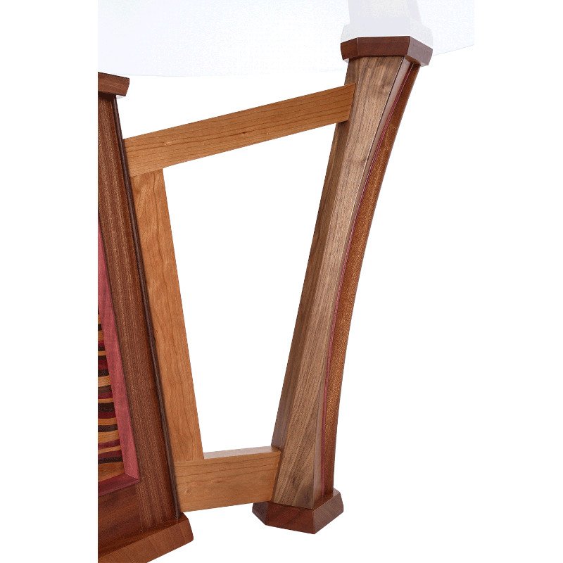 Close-up of a wooden table leg with angled side supports and a horizontal support beam.