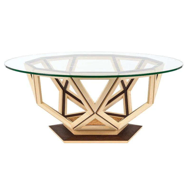A modern glass-top coffee table with a geometric wooden base and pentagonal dark wood platform.