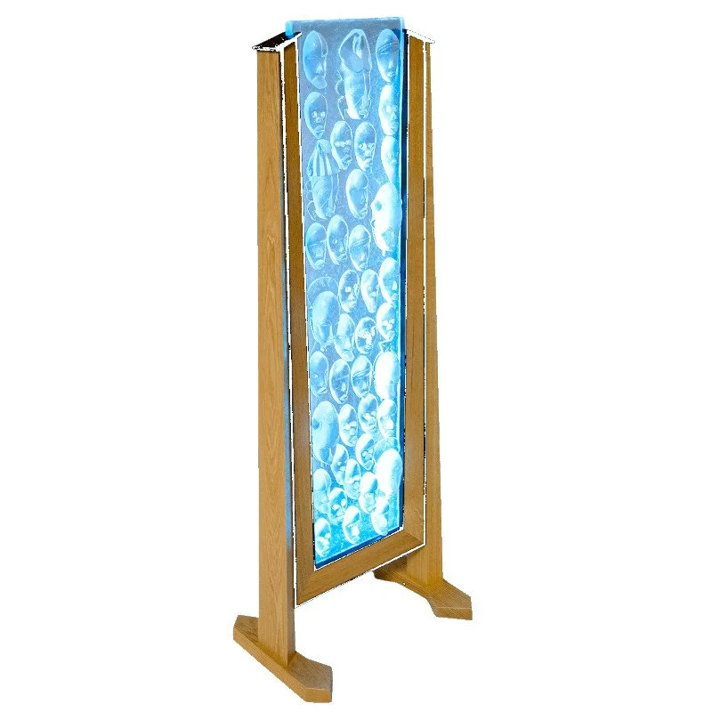 A wooden standing display with illuminated glass featuring multiple images of human heads.