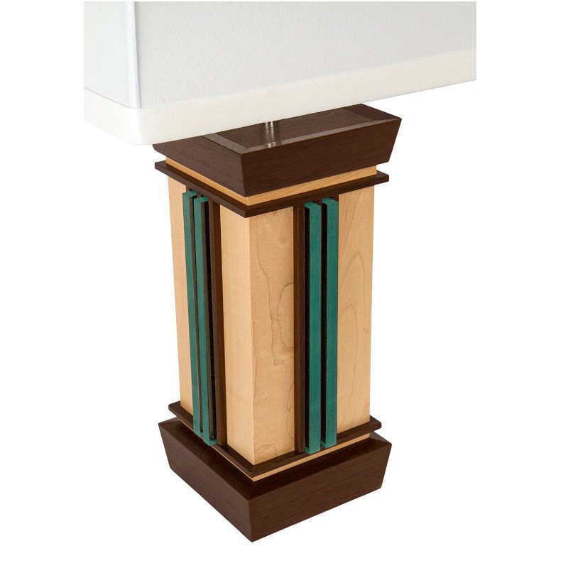 A modern lamp with decorative teal acrylic vertical stripes on the sides.