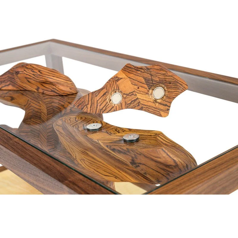 A custom coffee table with a sculpture that passes through the glass.