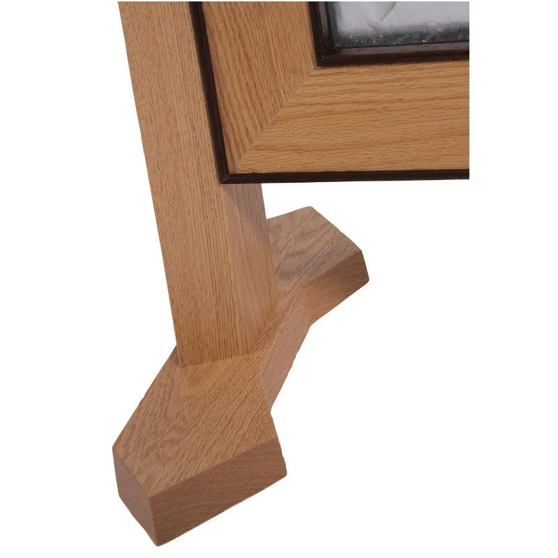 Close-up of a foot on a wooden frame holding art glass.