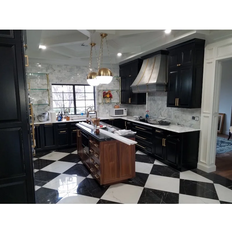 Custom made luxury kitchen with black cabinets, checkered flooring, and coffered ceiling..