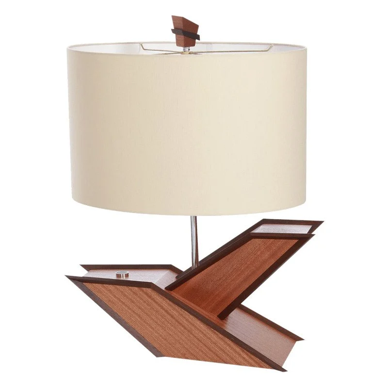 Modern table lamp with a unique angular wooden base and a large cream-colored lampshade.