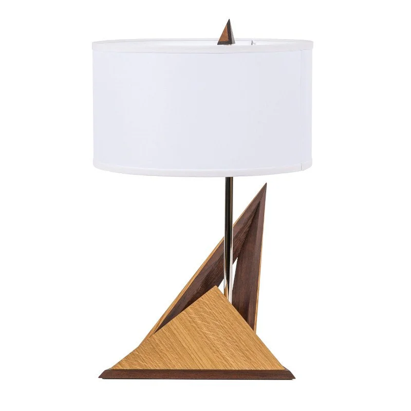 Modern table lamp with a geometric wooden base and a white lampshade.