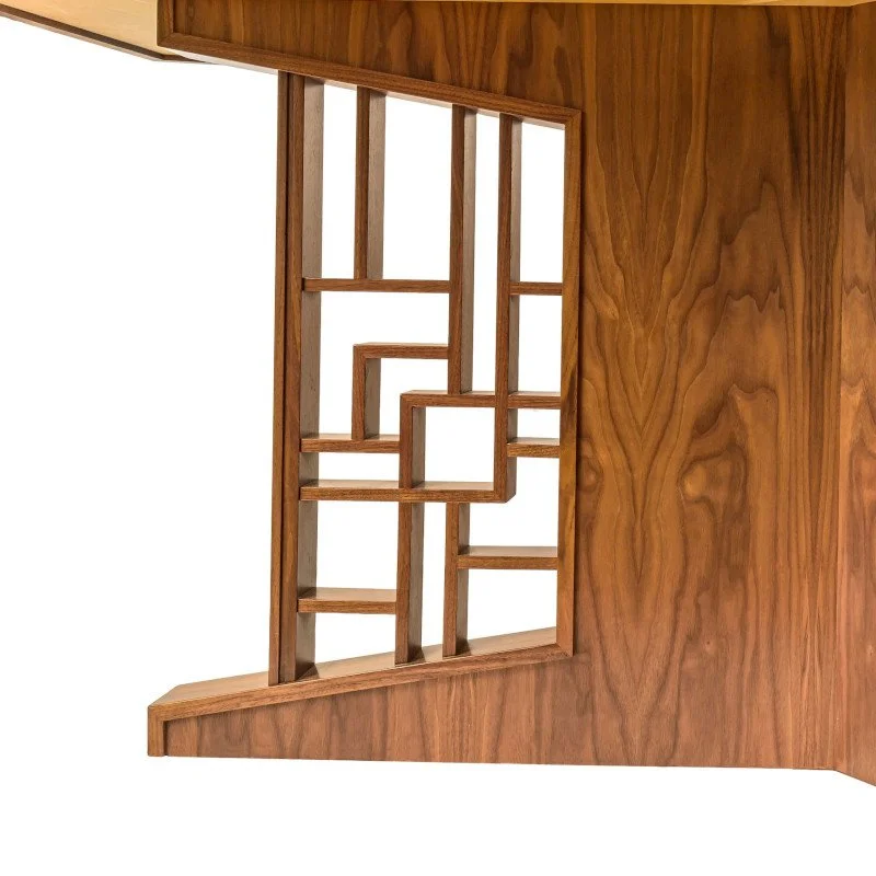 A wooden table base with geometric patterns.