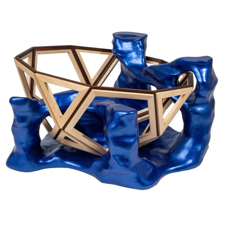Decorative coffee table art piece resembling a gemstone surrounded by blue metallic wooden carved base.