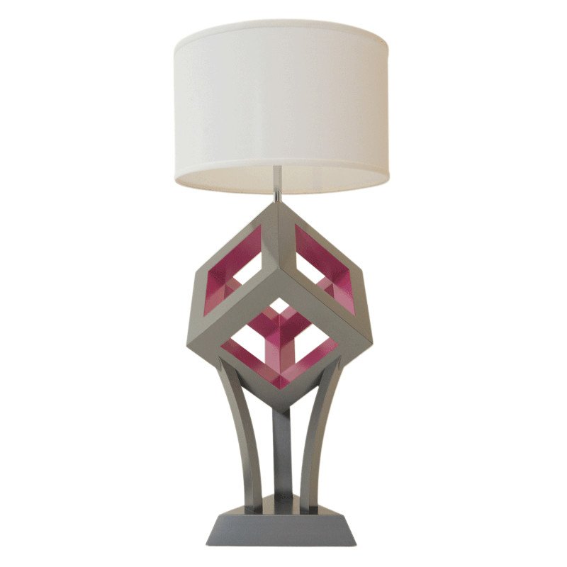 Decorative table lamp with geometric cube design, triangular base, and white lampshade.