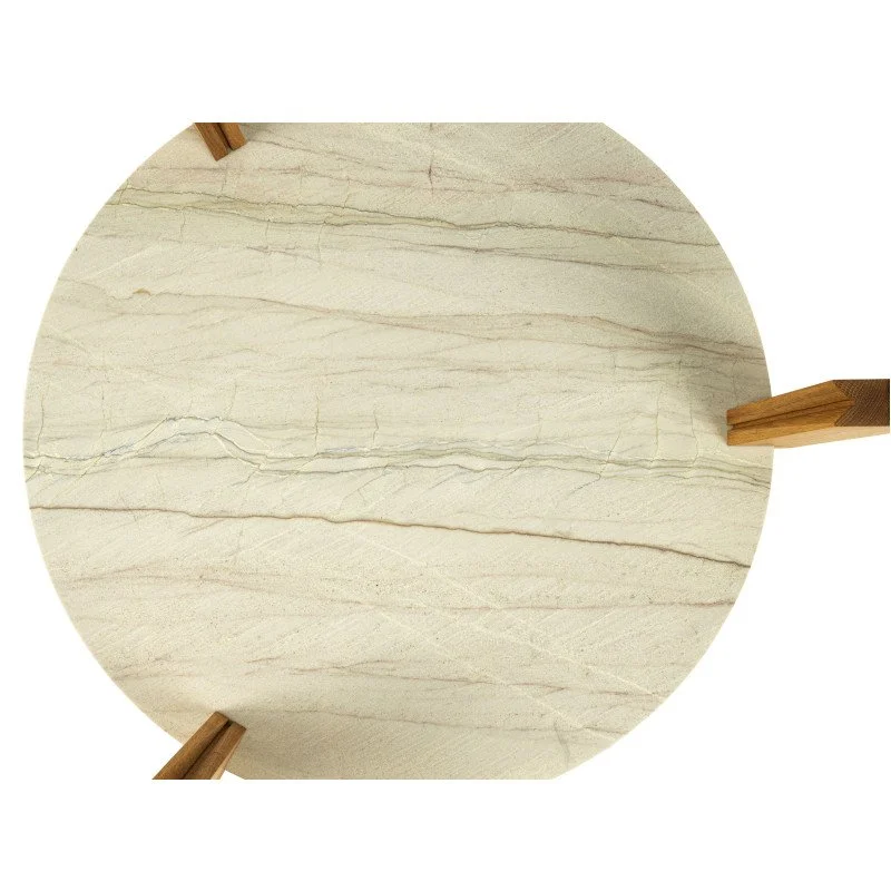 Top view of a round, cream-colored marble table with wooden legs.