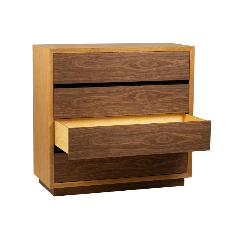Wooden chest of drawers with four drawers, one of which is partially pulled out.
