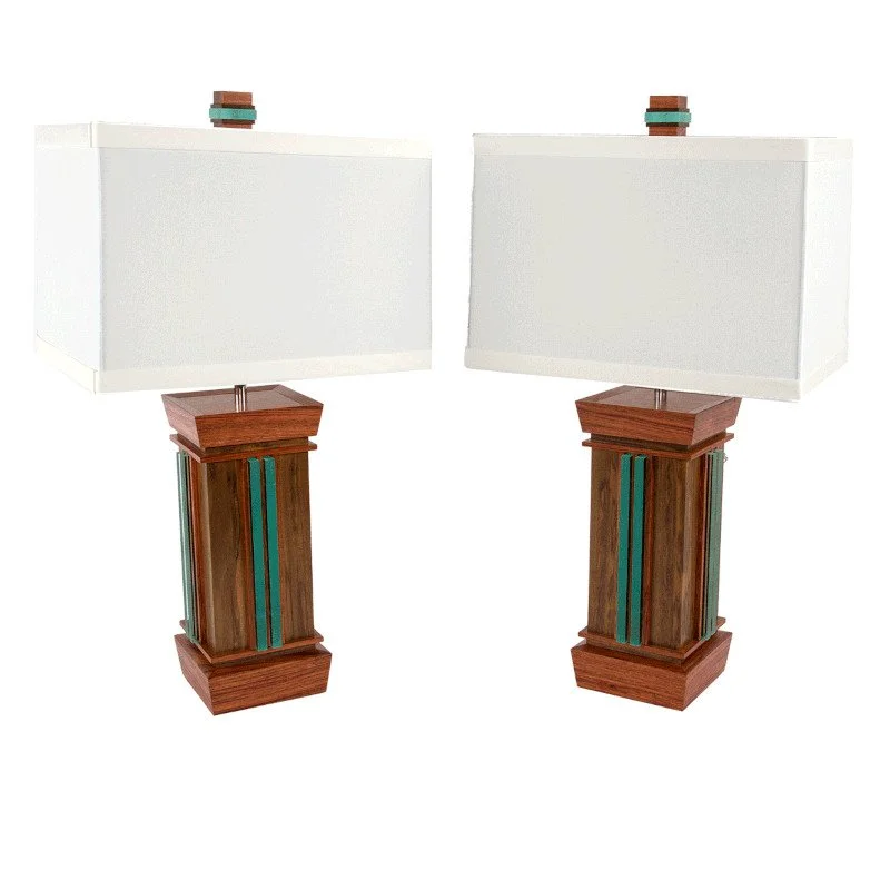 Two matching table lamps with wooden bases and off-white rectangular lampshades, each topped with small decorative finials, set against a plain white background.