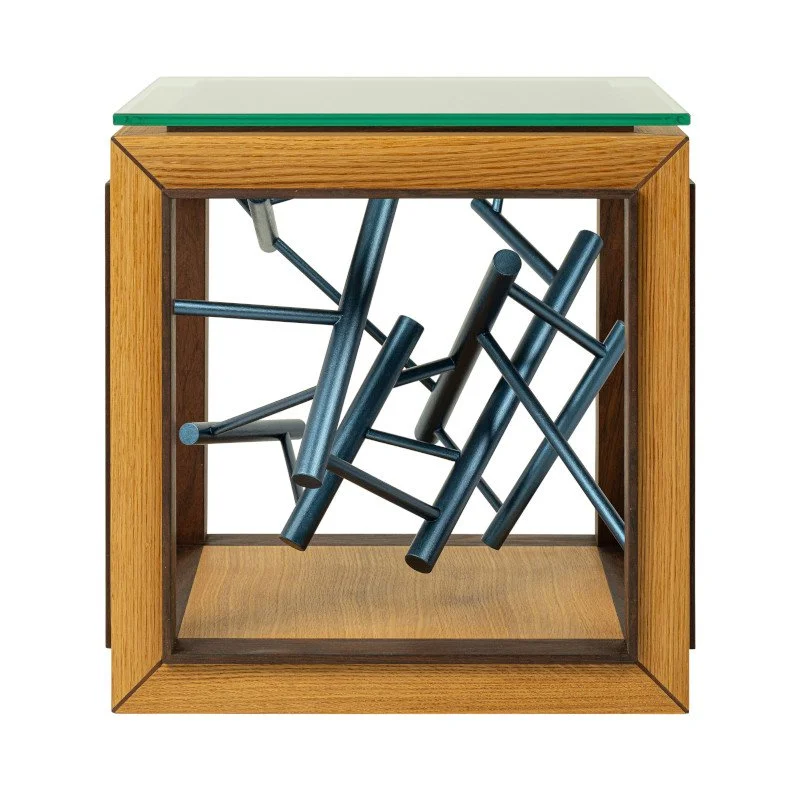 A wooden side table with a glass top, containing a painted sculpture in suspension.