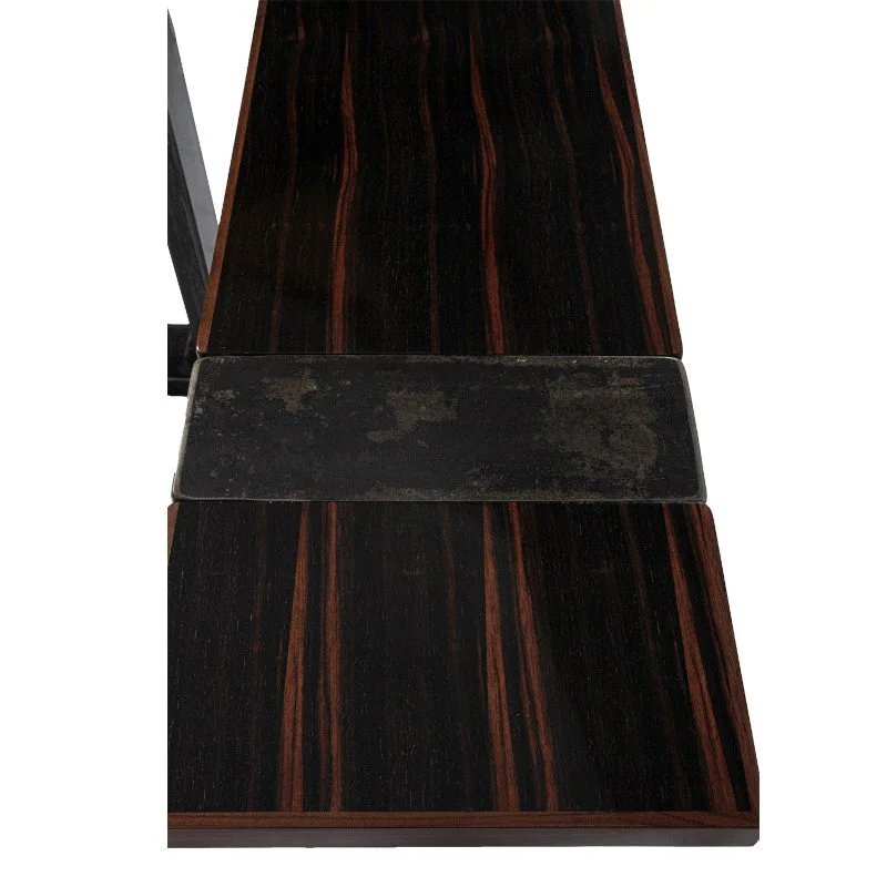 A close-up of a wooden table with metal accent.