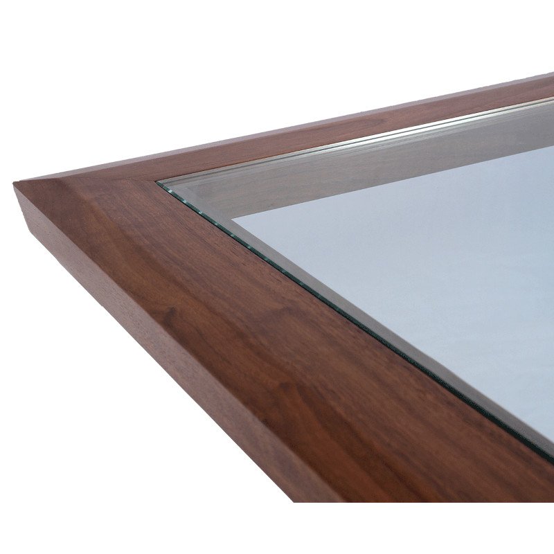 Close-up of a wooden table frame with glass, seen from an angle.