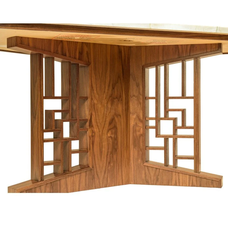 A custom made table base with geometric patterns in walnut.