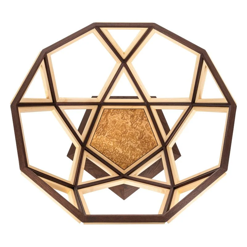 A geometric wooden coffee table with pentagons and triangles featuring tamo ash veneer.