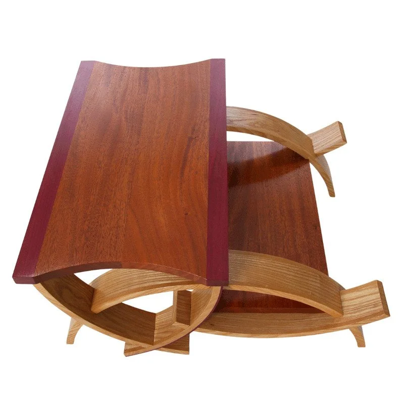 A custom made step stool with curved legs and exotic hardwoods.