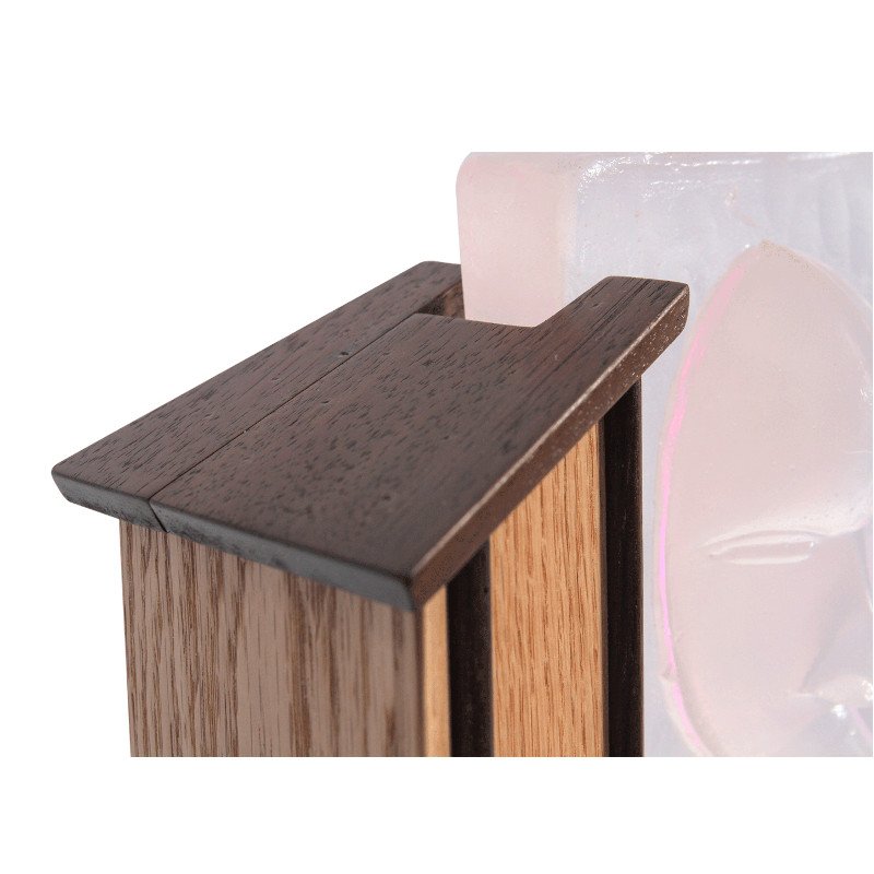 Close-up of the top of a wooden frame holding a piece of custom art glass.