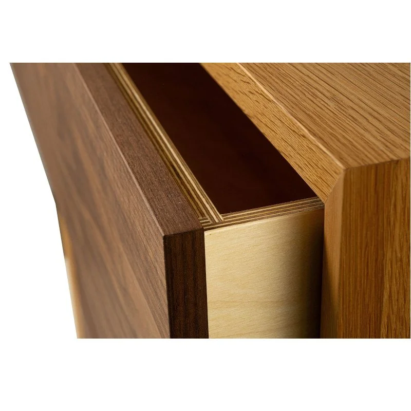 Close-up of a wooden drawer with multi-tone wood finish, partially open to show interior.