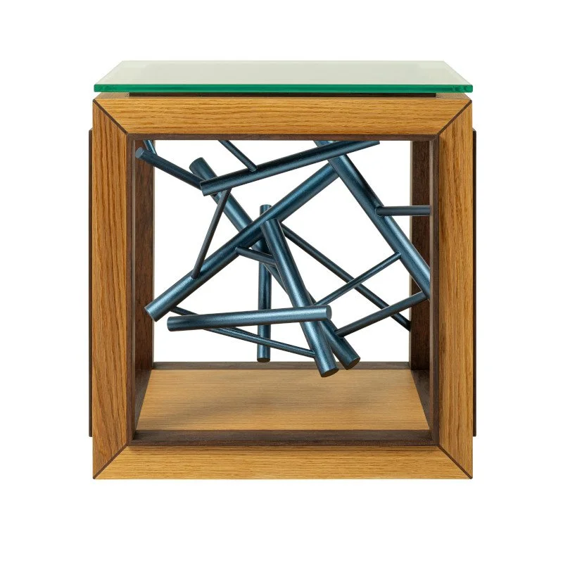 A custom made modern side table with a wooden frame, glass top, and a geometric sculpture in the base.