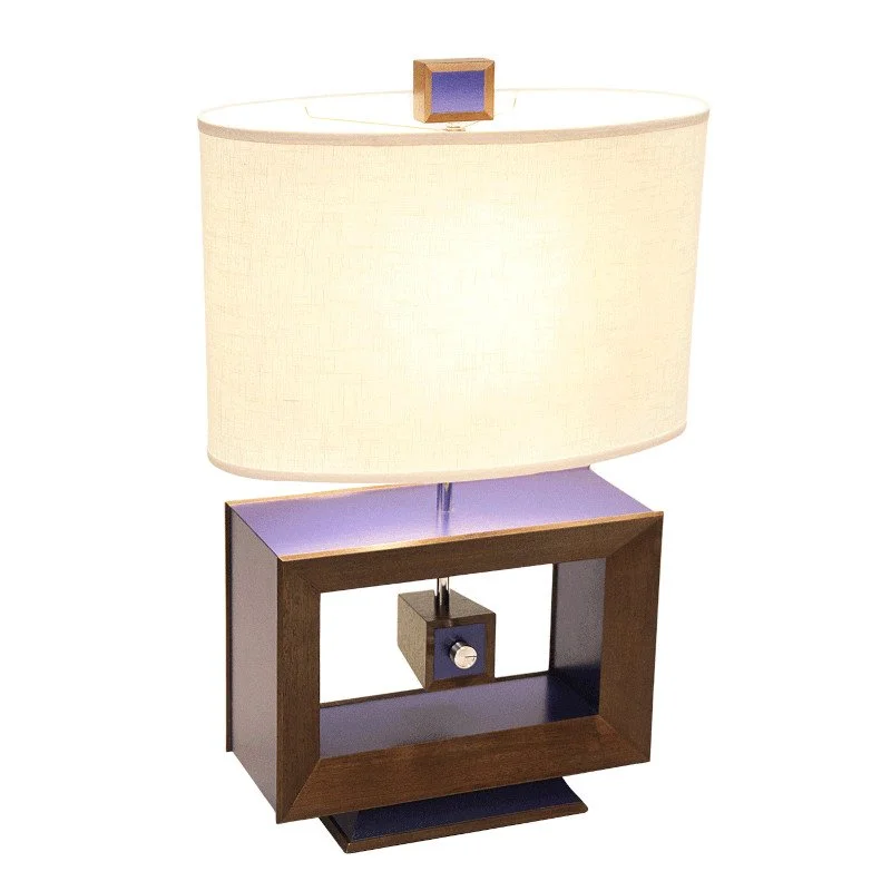 A modern table lamp with a rectangular wooden base and a box-shaped component with a switch.