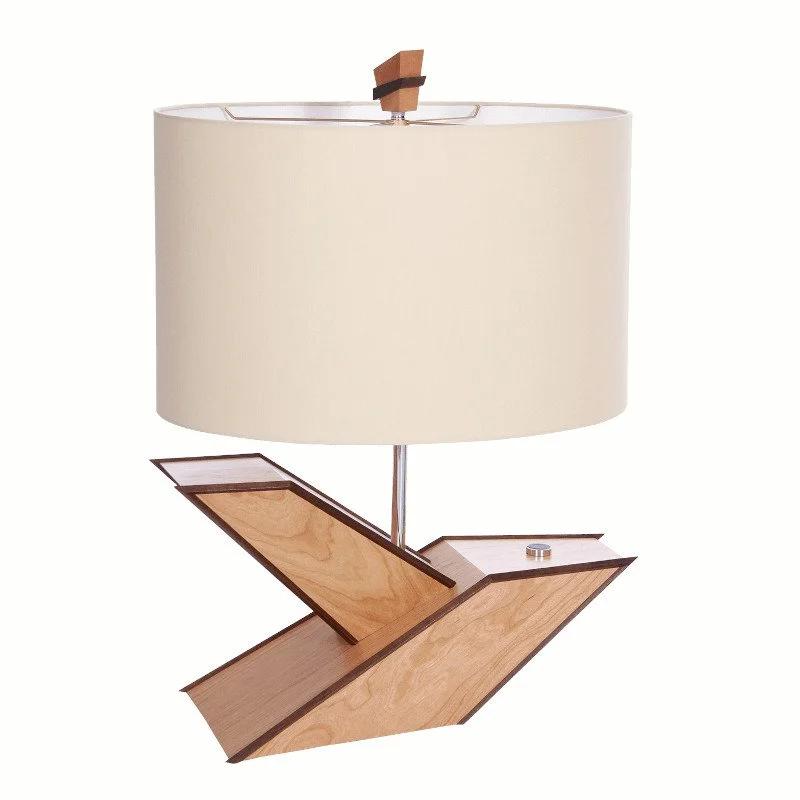 A modern table lamp with a wooden base and a large cream-colored lampshade.