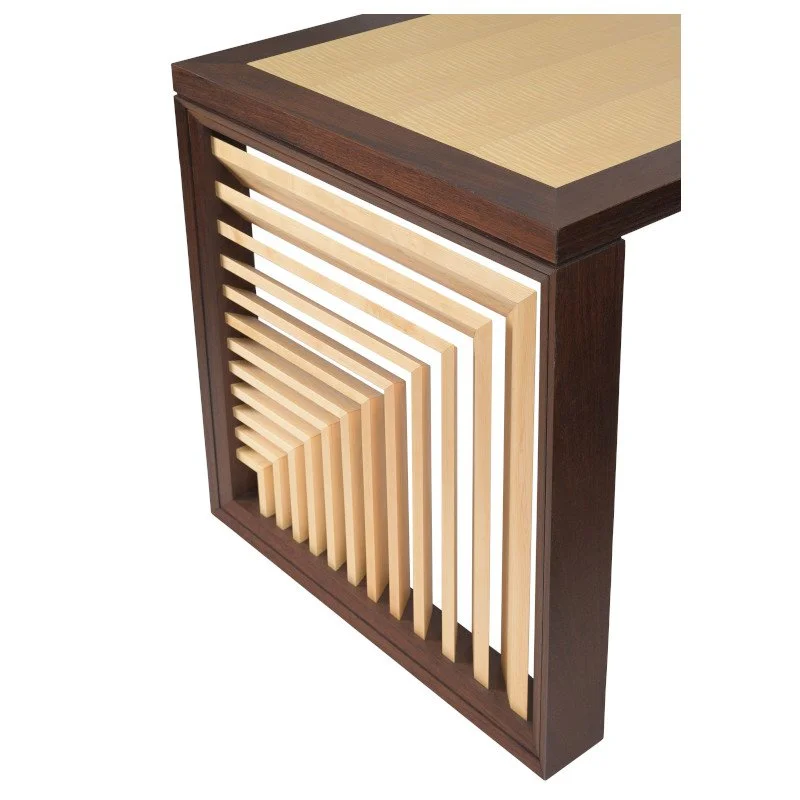 A modern wooden writing desk with a geometric pattern of light and dark wood slats on its side leg.