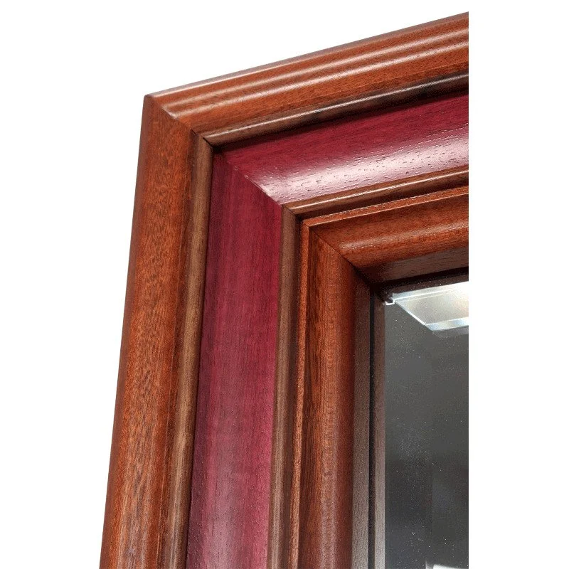 Close-up of a wooden picture frame corner with natural hardwoods.