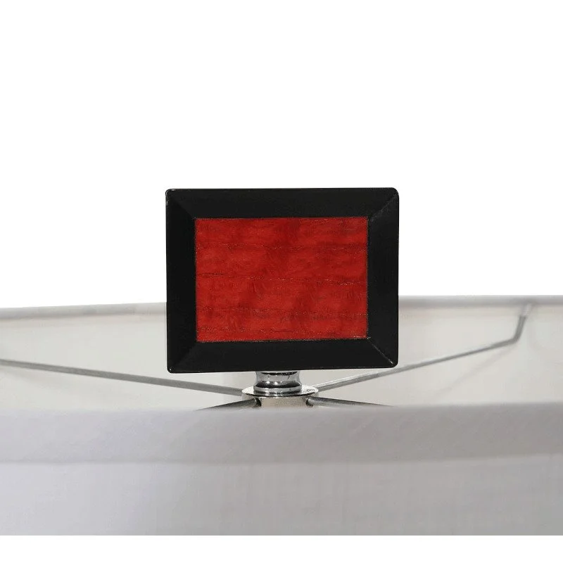 A small rectangular lamp finial made of wood with red dye stain and black paint.