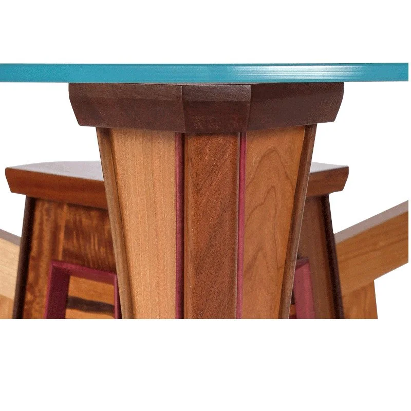 Close-up of a contemporary wooden dining table with glass tabletop.