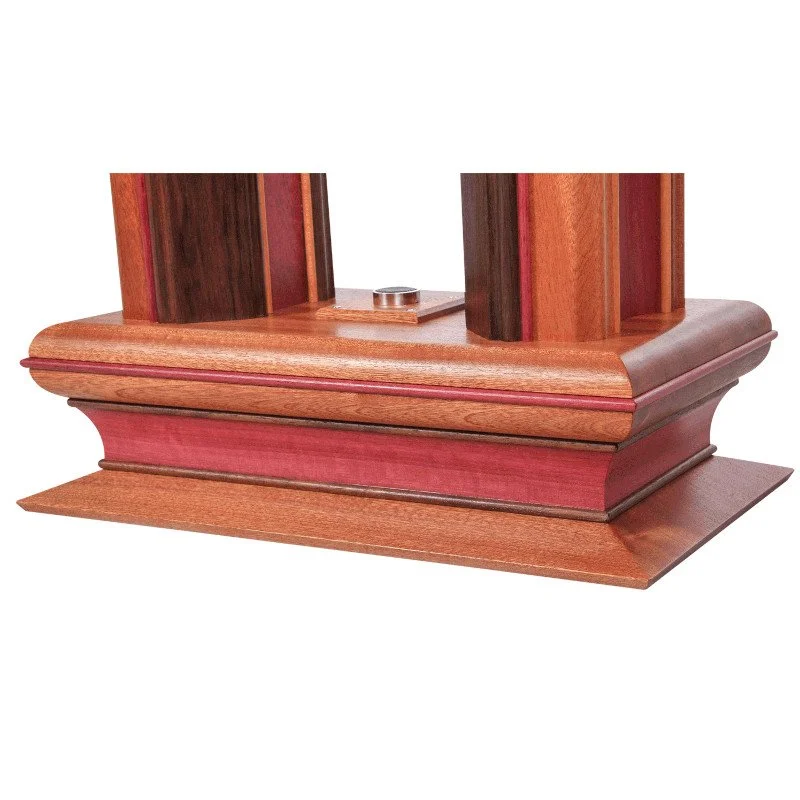 Close-up of a wooden lamp base with a chrome power switch.