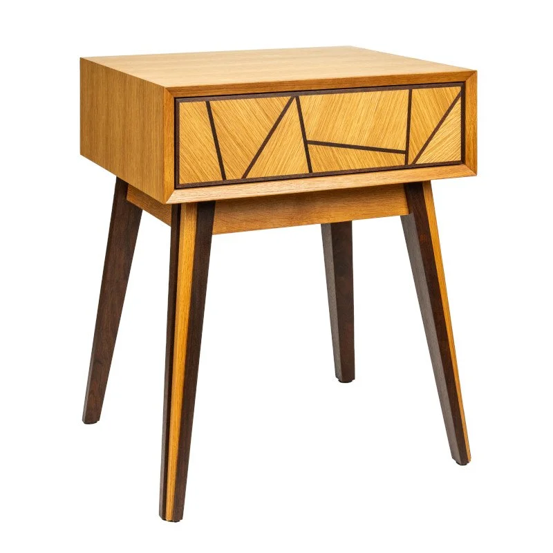 A wooden bedside table with geometric black line patterns on the front drawer, four angled legs, and a mid-century modern style.