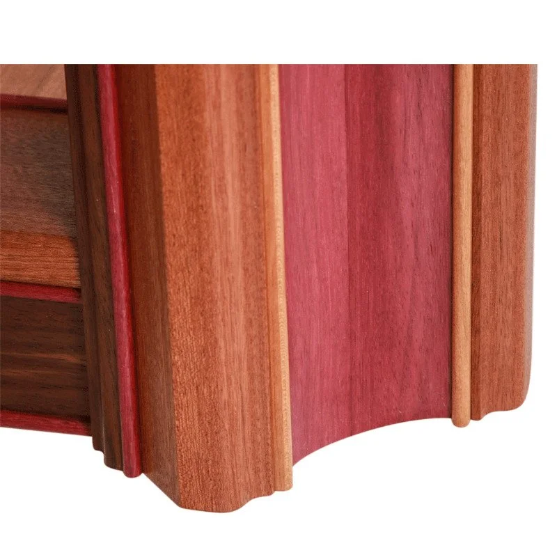 Close-up of a wooden wooden coffee table leg with multicolored vertical panels, featuring reddish and brown hues with a curved bottom edge.