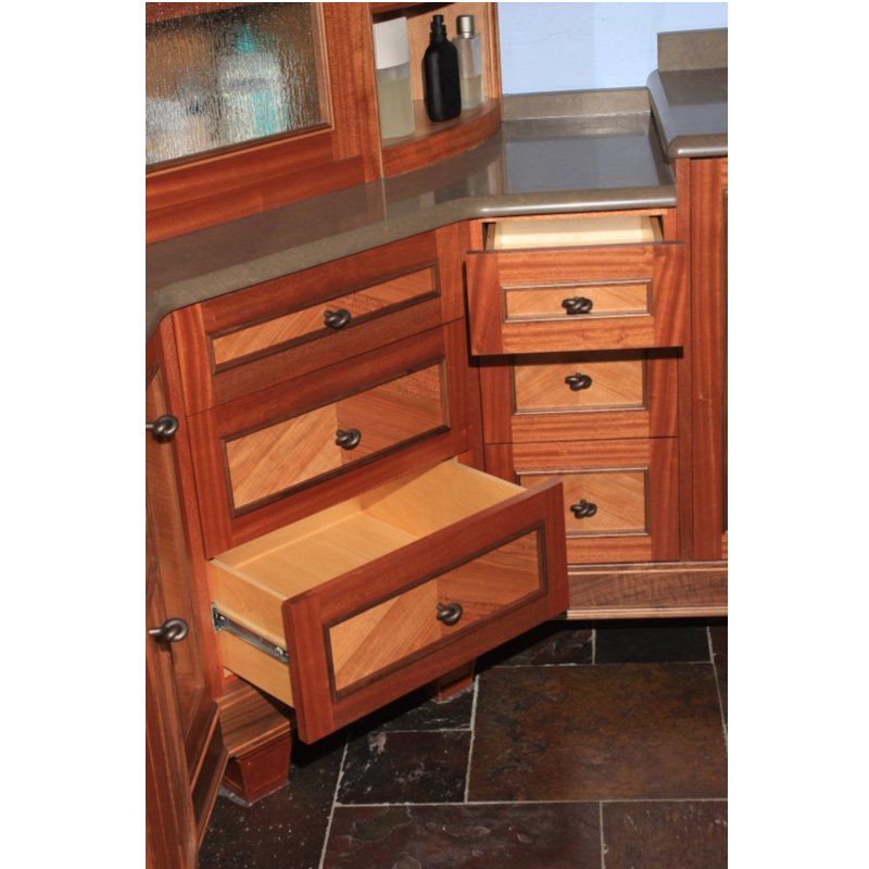 Open vanity drawer with empty interior, part of wooden cabinetry in a bathroom.