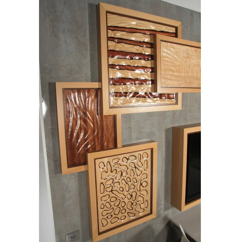 Collection of four wooden textured art panels, mounted on a gray tiled wall.