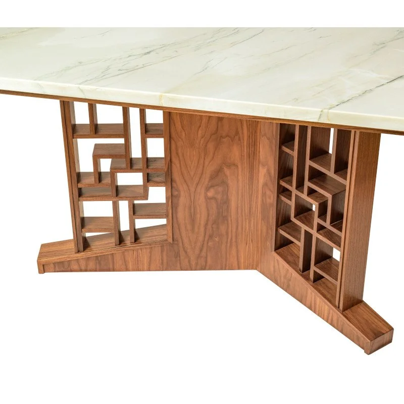 A wooden table with a stone top, featuring a unique base with open geometric lattice work on both sides.
