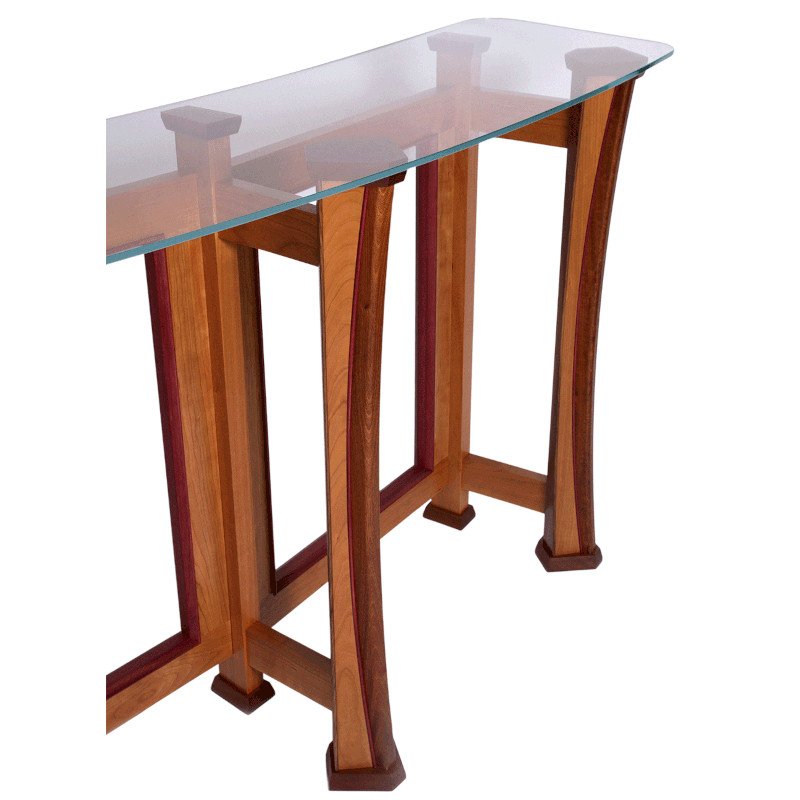 A wooden console table with curved legs and a glass top.